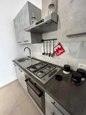 a kitchen with a sink and a stove top oven at La Cupola - casa vacanze n 8 in Termini Imerese