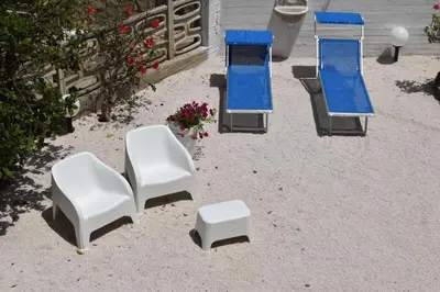 a group of chairs and a table and a stool at b&b Lastracu in Castellammare del Golfo