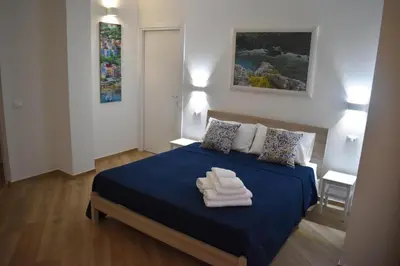 a bedroom with a blue bed with towels on it at b&b Lastracu in Castellammare del Golfo