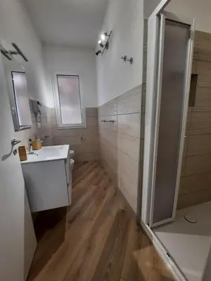 a bathroom with a white sink and a shower at b&b Lastracu in Castellammare del Golfo