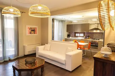 a living room with a white couch and a table at Villa Lidia in Balestrate