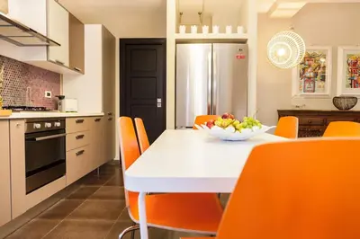 a kitchen with a table with a bowl of fruit on it at Villa Lidia in Balestrate