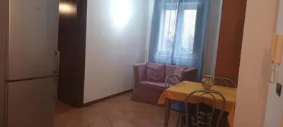 a kitchen with a table and a purple chair and a table and a table at Casa Vacanza Edy in Palermo