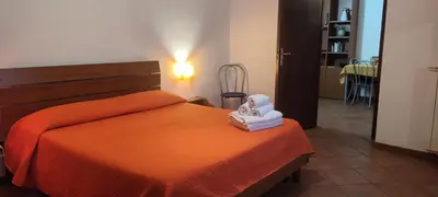 a bedroom with an orange bed with two towels on it at Casa Vacanza Edy in Palermo