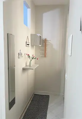 a bathroom with a mirror and a vase with flowers at La casa di Angela in Monreale