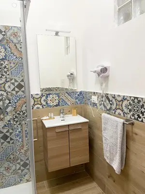 a bathroom with a sink and a shower at La casa di Angela in Monreale
