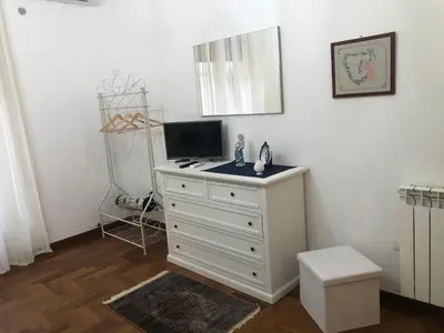 a white dresser with a television on top of it at G&G ROOMS in Palermo