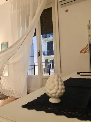 a white sculpture on a table in a room with a window at G&G ROOMS in Palermo