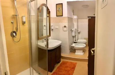 a bathroom with a shower and a sink and a toilet at G&G ROOMS in Palermo