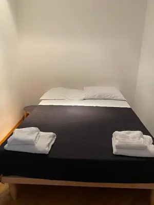a bed with two towels on top of it at Casamu' Management Apartment Palermo in Palermo