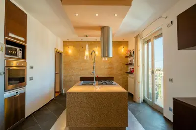 a kitchen with a island in the middle of a room at Casamu' Management Apartment Palermo in Palermo
