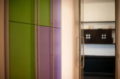 a green and purple refrigerator in a room at Casamu' Management Apartment Palermo in Palermo