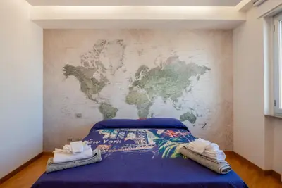 a bedroom with a map of the world on the wall at Casamu' Management Apartment Palermo in Palermo