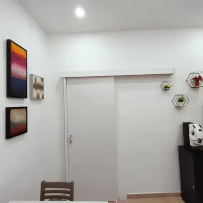 a room with a white wall with a sliding door at La Casetta di Angy in Palermo