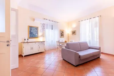 a living room with a couch and a table at Viola's Luxury House in Palermo
