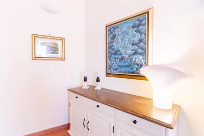 a white room with a painting on the wall at Viola's Luxury House in Palermo