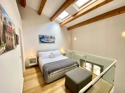 a small bedroom with a bed in a room at The Unique Loft Maqueda - in the city centre in Palermo