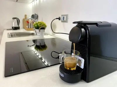 a coffee maker sitting on a counter with a cup of coffee at The Unique Loft Maqueda - in the city centre in Palermo