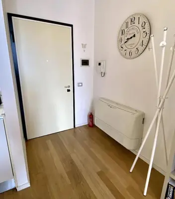a room with a door and a clock on the wall at The Unique Loft Maqueda - in the city centre in Palermo