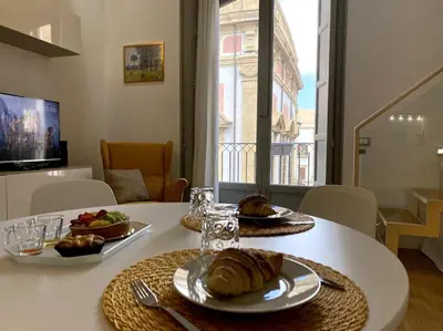 a white table with two plates of food on it at The Unique Loft Maqueda - in the city centre in Palermo