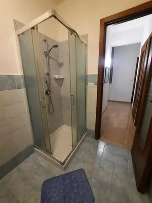 a shower with a glass door in a bathroom at Domus Oreto in Palermo