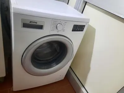 a white washing machine sitting in a kitchen at Domus Oreto in Palermo