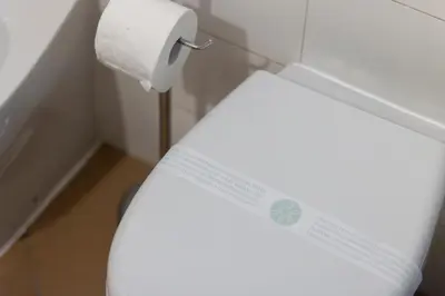 a toilet in a bathroom with a roll of toilet paper at Arco di Bonello Cattedrale in Palermo