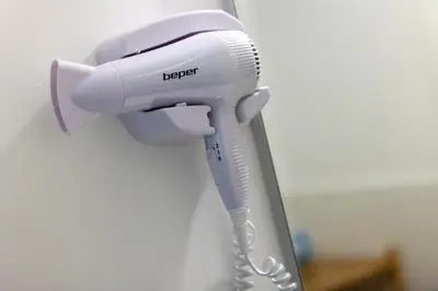 a hair dryer hanging on a wall at Arco di Bonello Cattedrale in Palermo