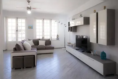 a living room with a couch and a tv at Nelly Casa Vacanze in Porticello
