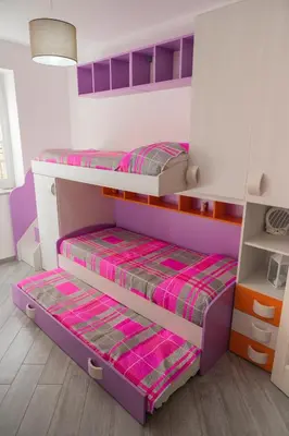 two bunk beds in a room with pink and purple at Nelly Casa Vacanze in Porticello
