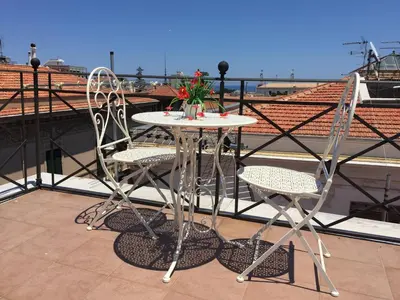 a table and two chairs on a balcony at La Cupola in Palermo