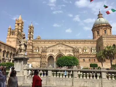 a large building with people walking in front of it at La Cupola in Palermo