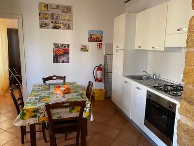 a kitchen with a table and a sink and a stove at La Cupola in Palermo