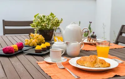 a table with breakfast foods and drinks on it at A Casa del Gioielliere in Palermo