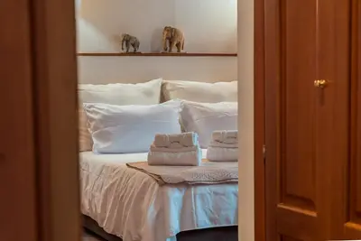 a bedroom with a bed with towels on it at A Casa del Gioielliere in Palermo