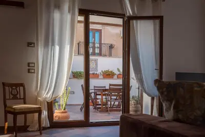a living room with a sliding glass door to a patio at A Casa del Gioielliere in Palermo