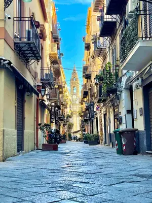 an empty street with a building in the distance at A Casa del Gioielliere in Palermo