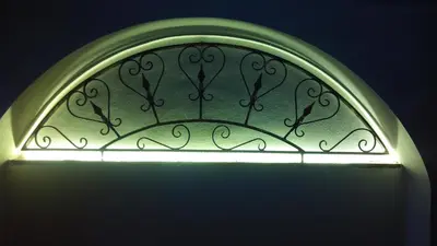 a green glass window with a light on it at Baglio Poma in Castelluzzo