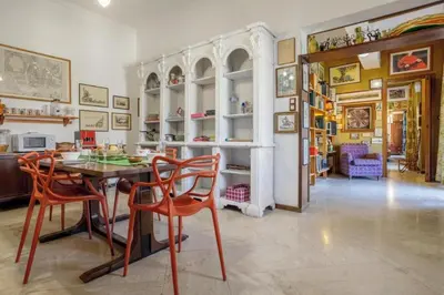 a dining room with a table and chairs at Artist penthouse 2 in Palermo