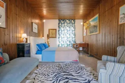 a bedroom with a bed and a zebra rug at Artist penthouse 2 in Palermo