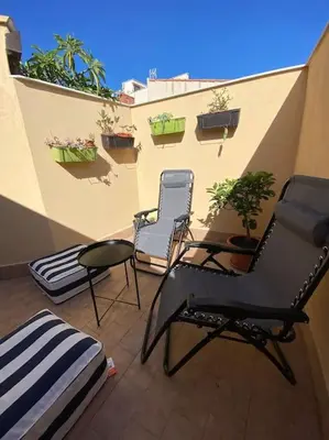 two chairs and a table on a balcony at Casamartú Apartment in Palermo