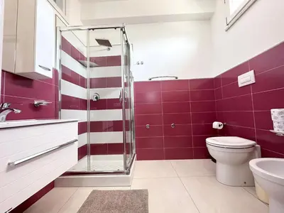 a bathroom with a toilet and a glass shower at Mare Blu Apartament in Balestrate
