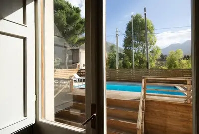 a view from the door of a house with a swimming pool at Villa Paradiso in Castelluzzo