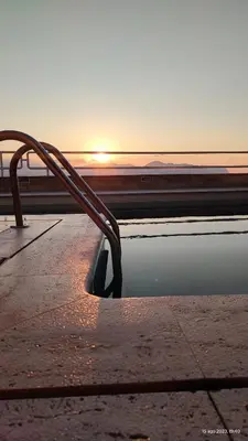 a pool of water with the sunset in the background at Sea Sicily View in Bagheria