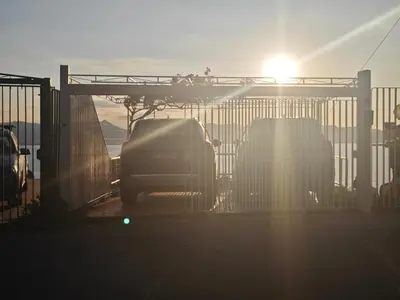 a group of cars parked behind a fence at Sea Sicily View in Bagheria