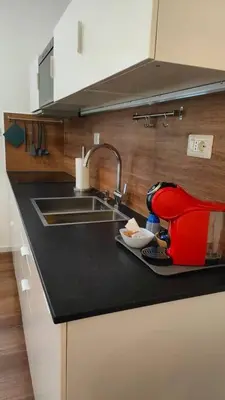 a kitchen with a sink and a red mixer on a counter at GIO&GIO central house in Palermo