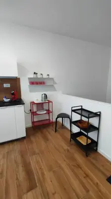 a room with a kitchen with a table and a shelf at GIO&GIO central house in Palermo