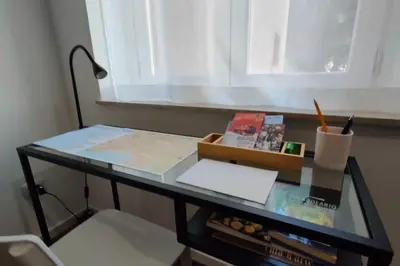 a glass table with a desk with a window at GIO&GIO central house in Palermo