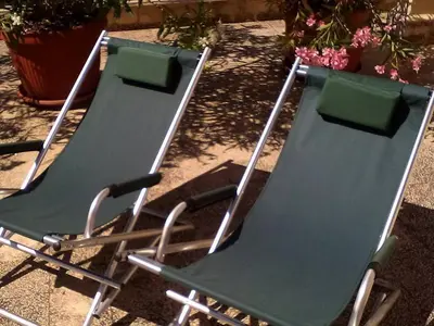 two green chairs sitting next to each other at Il Terrazzo Di Oleandri in Bagheria