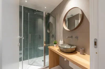 a bathroom with a sink and a shower with a mirror at Casa Valverde in Centro Storico by Wonderful Italy in Palermo